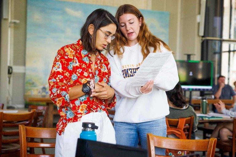 Two students review paper.